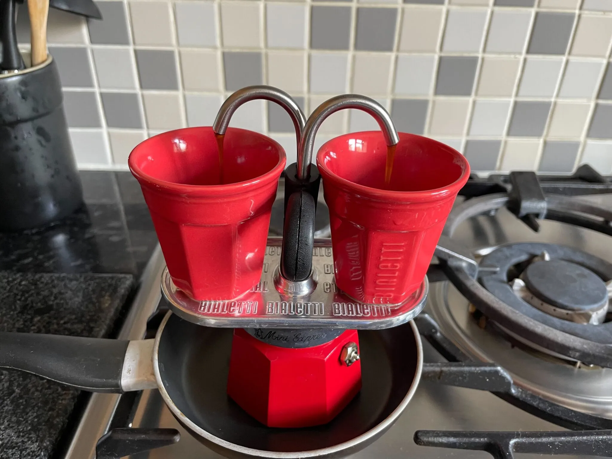 My 2 cup Bialetti Mini Express with two espresso cups slowly filling with delicious nectar