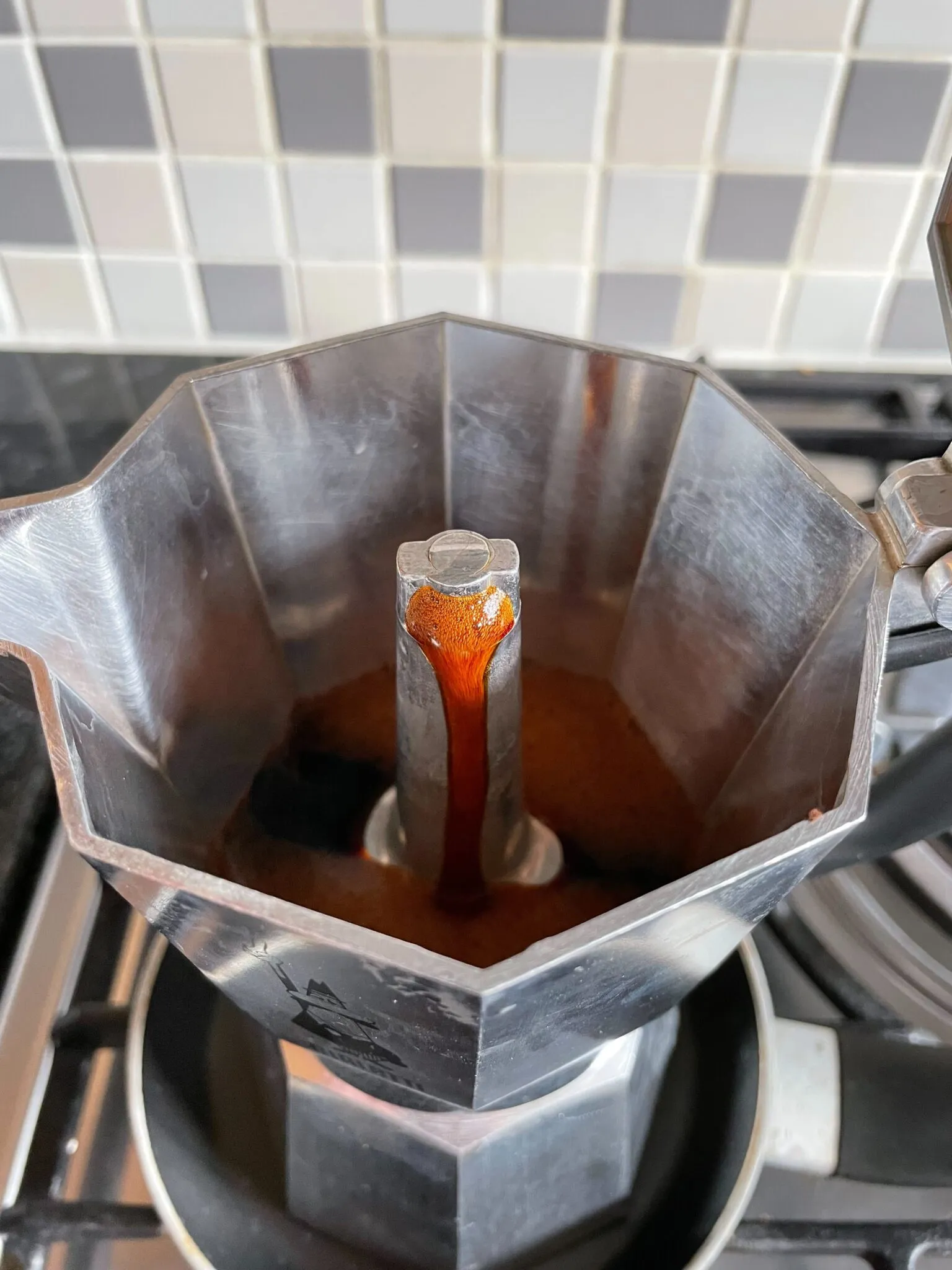 Freshly brewed coffee oozing from the spout inside my Bialetti Moka Express